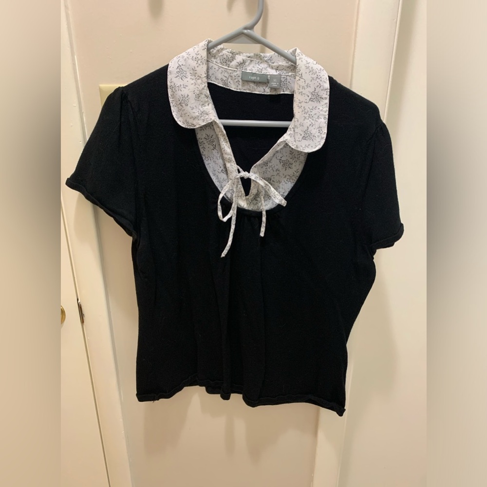 Black top with white collar and tie